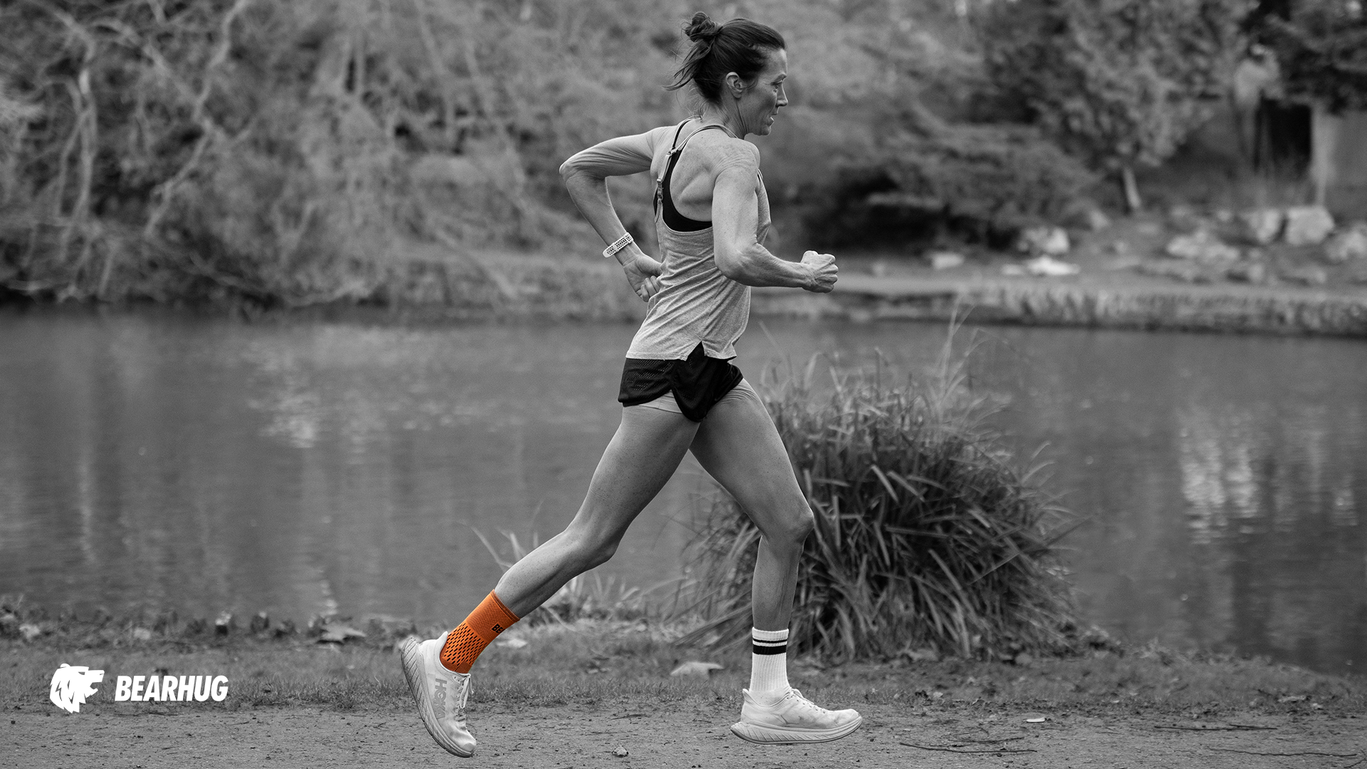 Woman running outdoors wearing Bearhug ankle support for stability