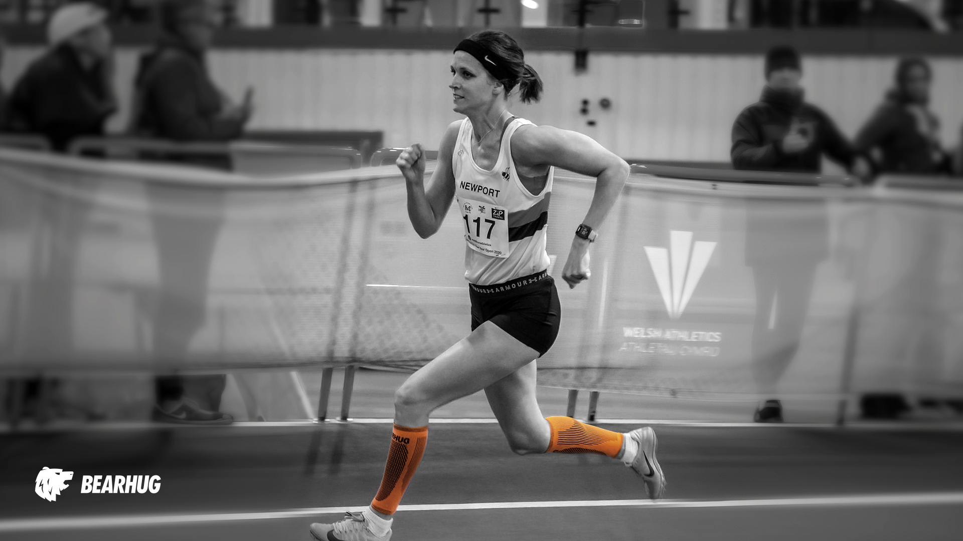 Female athlete sprinting with Bearhug calf support for muscle recovery