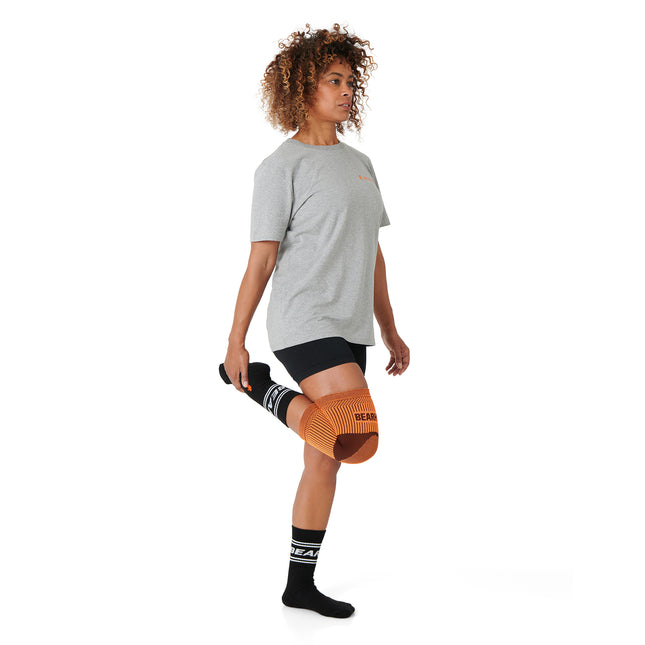 flexing a Knee Compression Support Sleeve For Arthritic Relief & Pain Recovery